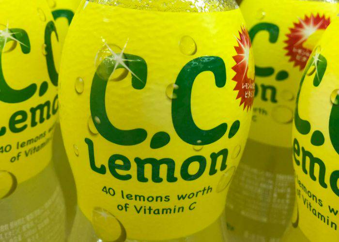 A close-up of the bright yellow label of C.C Lemon, including "40 lemons worth of vitamin C".